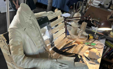 Robert Louis Stevenson figure and bench structure during the sculpting process