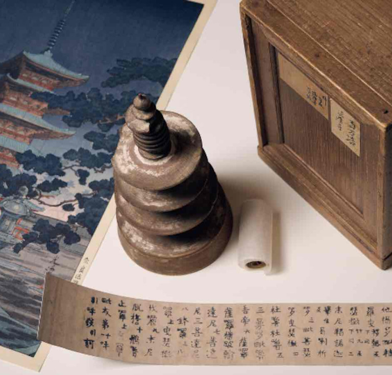 Hyakumantō Darani with wooden pagoda, storage box and facsimile text alongside a colour woodblock print of Horyuji Temple in Nara, Japan, where this particular darani was stored. Photo: Eugene Hyland. 